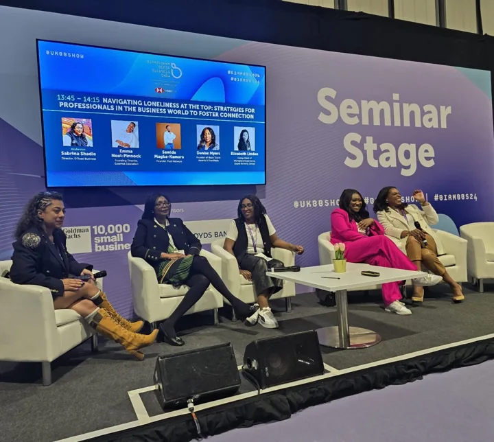 Emma taking part in a panel on a seminar stage.