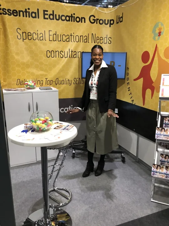 Emma standing beside an Essential Education Group exhibition stand.
