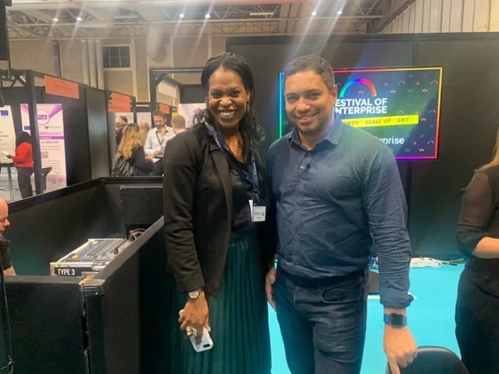 Emma standing beside another adult at an education exhibition.