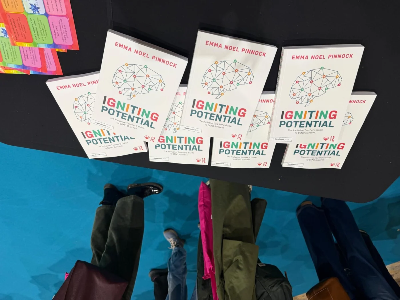 Copies of Igniting Potential displayed on an exhibition table.